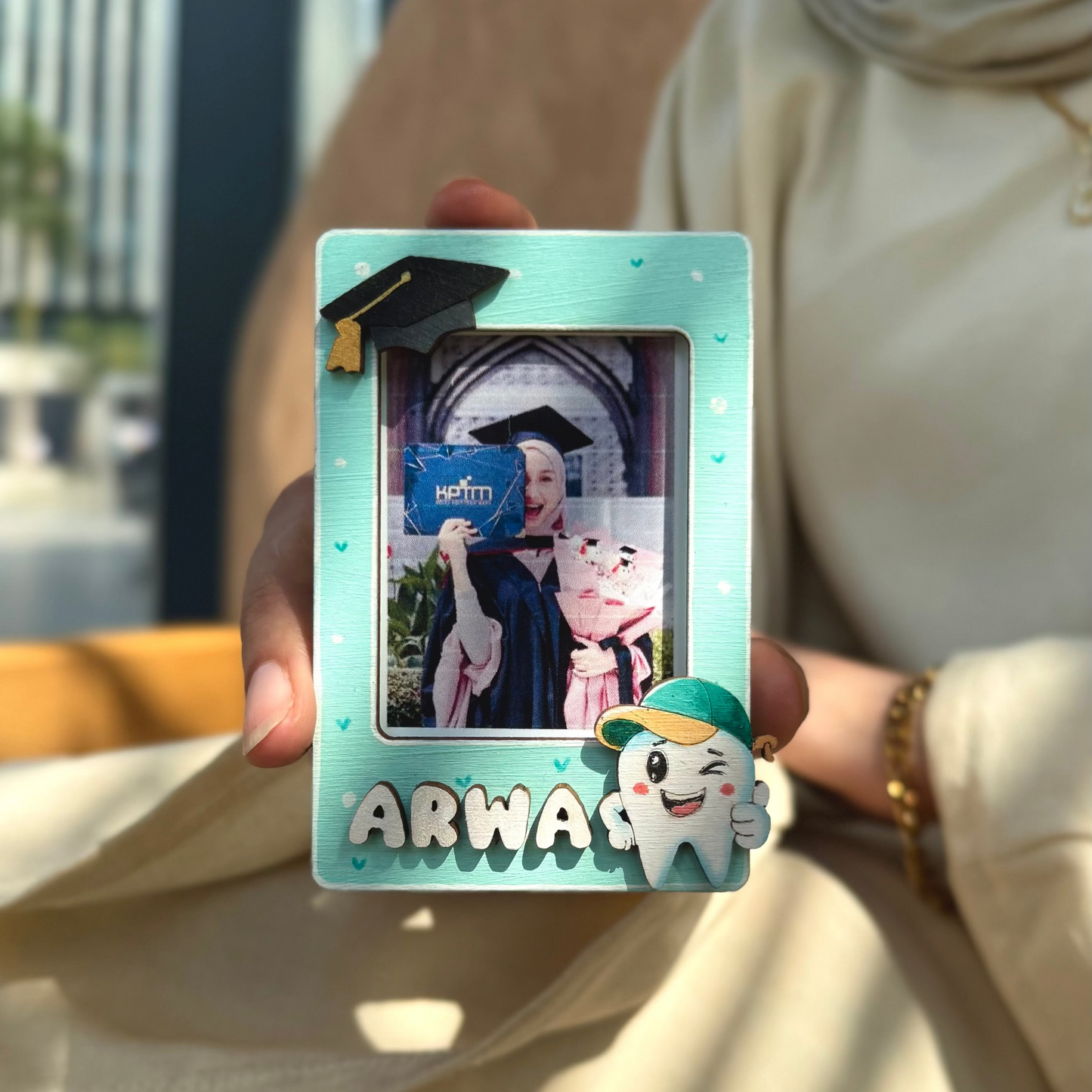 Person holding a product with 'ARW' branding in an outdoor setting